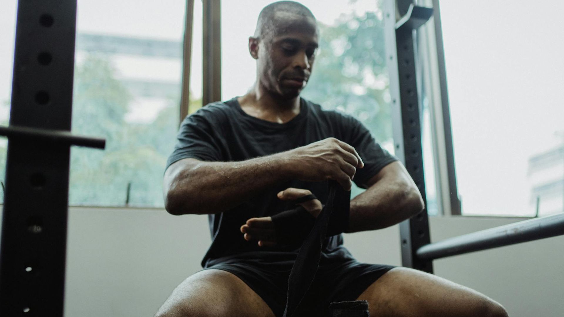 Athletic man preparing for workout in dark atmospheric gym