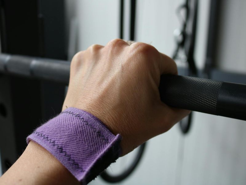 Close up of a man hand gripping a barbell handle