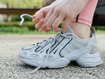 Man tying shoelaces before a morning workout session