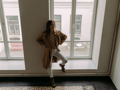 Silhouette of a person stretching in a bright studio